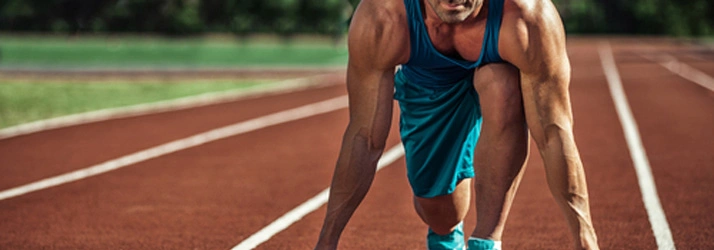 Runner in starting position on an outdoor track